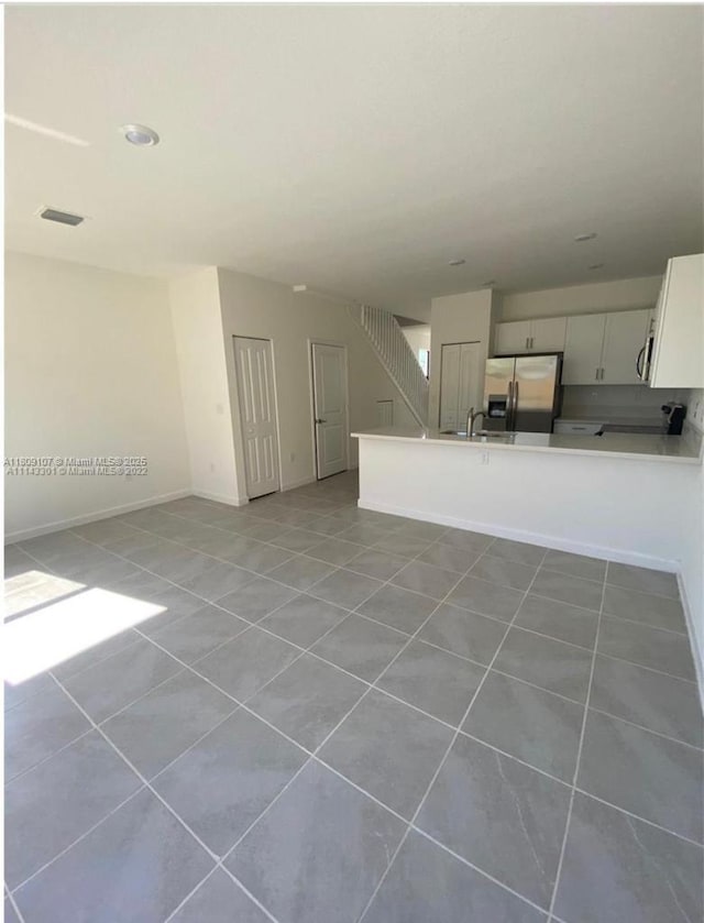 28729 SW 132nd Pl Unit 28729, Homestead, FL 33033 - unfurnished living room featuring light tile patterned flooring, a sink, and baseboards
