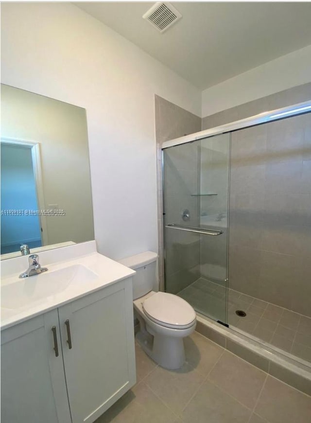 28729 SW 132nd Pl Unit 28729, Homestead, FL 33033 - bathroom featuring toilet, vanity, a stall shower, and tile patterned floors