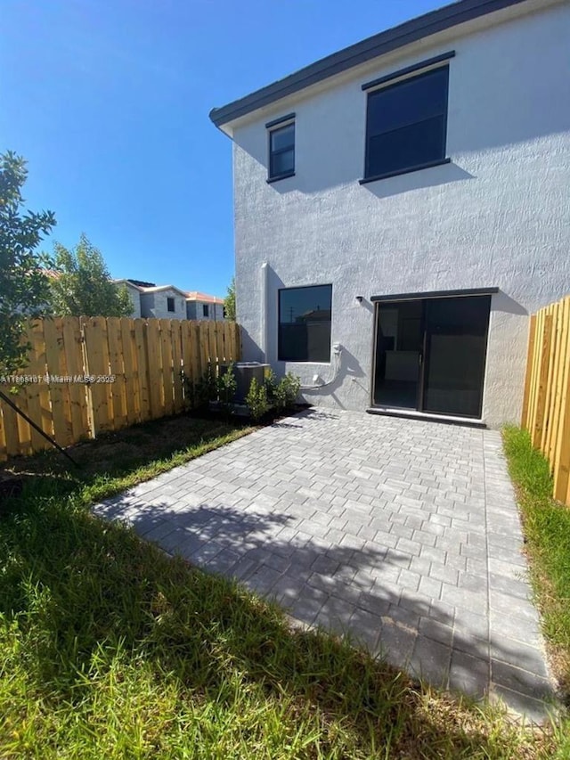 28729 SW 132nd Pl Unit 28729, Homestead, FL 33033 - rear view of house with stucco siding and a patio