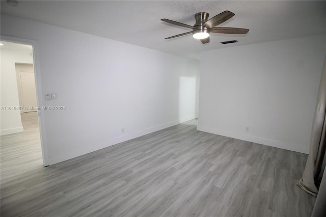 7204 NW 76th Dr, Tamarac, FL 33321 - empty room with ceiling fan, wood finished floors, and baseboards