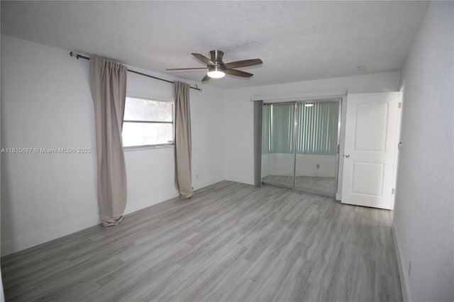 7204 NW 76th Dr, Tamarac, FL 33321 - unfurnished bedroom with wood finished floors, baseboards, a closet, and ceiling fan