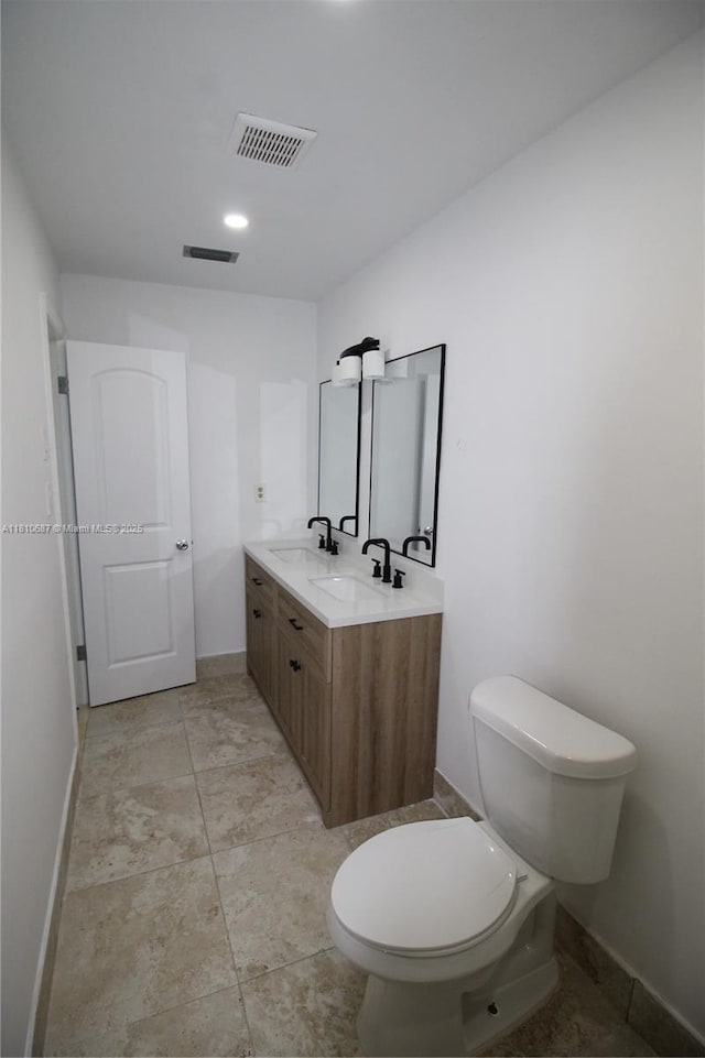 7204 NW 76th Dr, Tamarac, FL 33321 - bathroom with baseboards, toilet, and double vanity