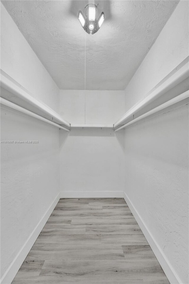 7204 NW 76th Dr, Tamarac, FL 33321 - walk in closet with wood finished floors