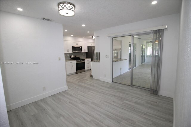 7204 NW 76th Dr, Tamarac, FL 33321 - unfurnished living room featuring light wood finished floors, recessed lighting, and baseboards