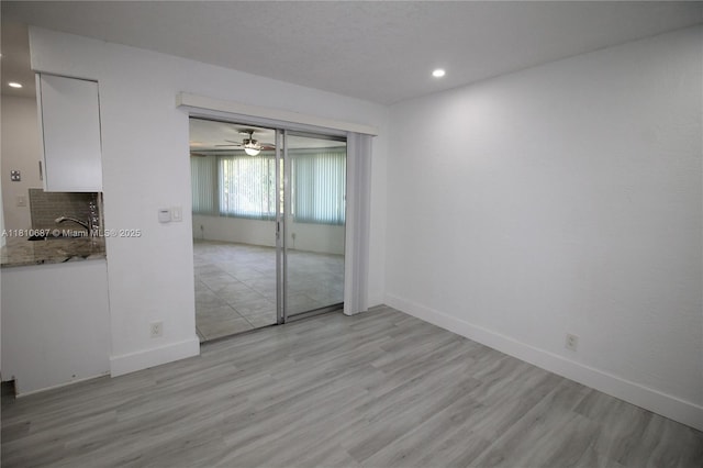7204 NW 76th Dr, Tamarac, FL 33321 - unfurnished bedroom with recessed lighting, light wood-style floors, a sink, and baseboards