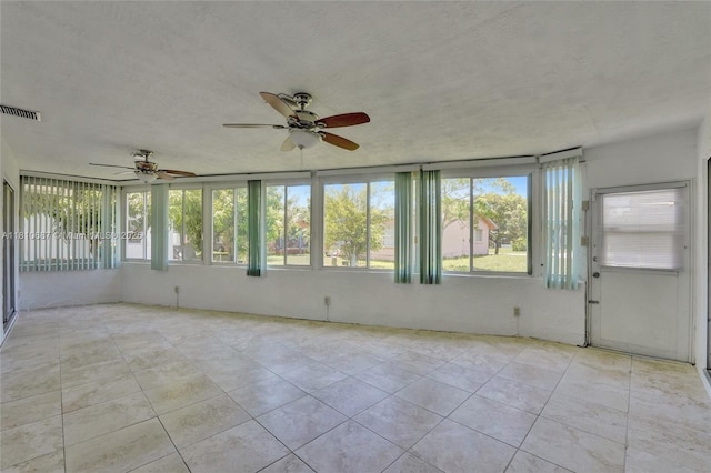 7204 NW 76th Dr, Tamarac, FL 33321 - unfurnished sunroom featuring tile patterned flooring and a textured ceiling