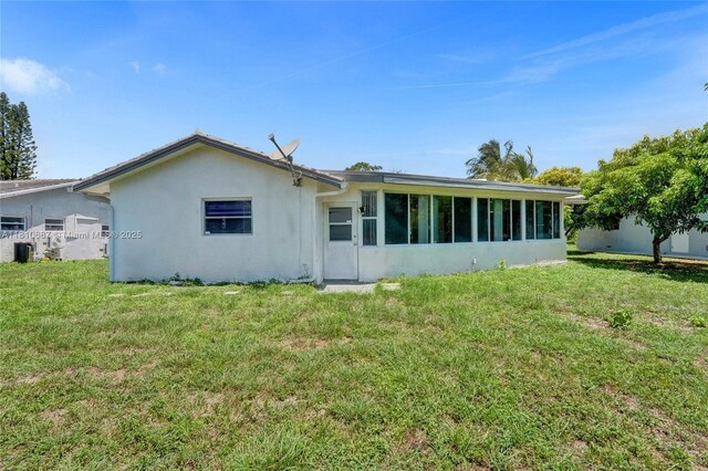 7204 NW 76th Dr, Tamarac, FL 33321 - rear view of house with stucco siding and a lawn