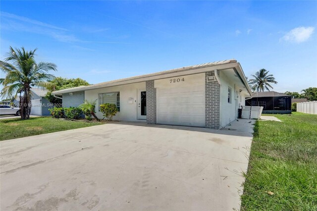 7204 NW 76th Dr, Tamarac, FL 33321 - ranch-style house featuring an attached garage, driveway, a front yard, and stucco siding