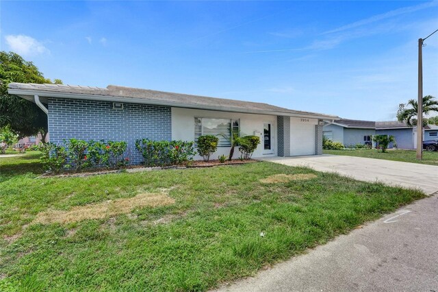 7204 NW 76th Dr, Tamarac, FL 33321 - ranch-style house with an attached garage, concrete driveway, a front yard, and brick siding