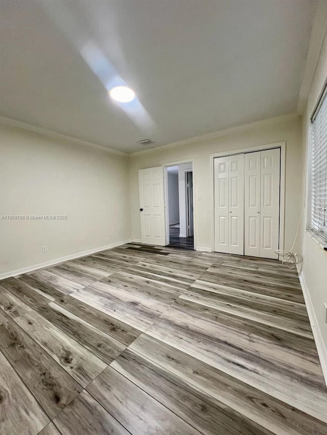 915 N 19th Ave, Hollywood, FL 33020 - unfurnished bedroom with ornamental molding, a closet, wood finished floors, and baseboards