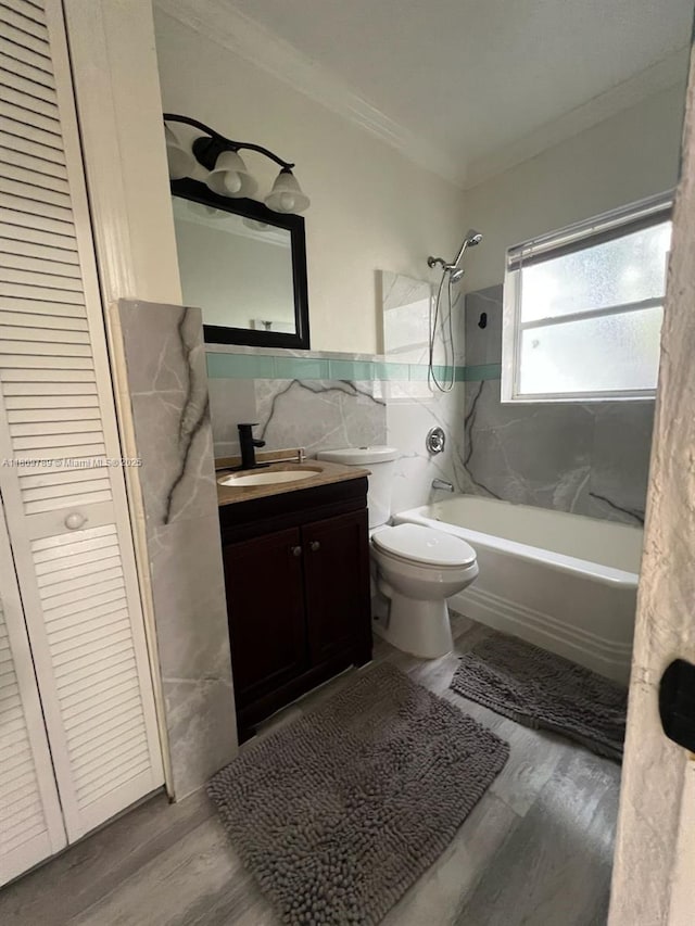 915 N 19th Ave, Hollywood, FL 33020 - bathroom with crown molding, tile walls, vanity, shower / washtub combination, and wood finished floors