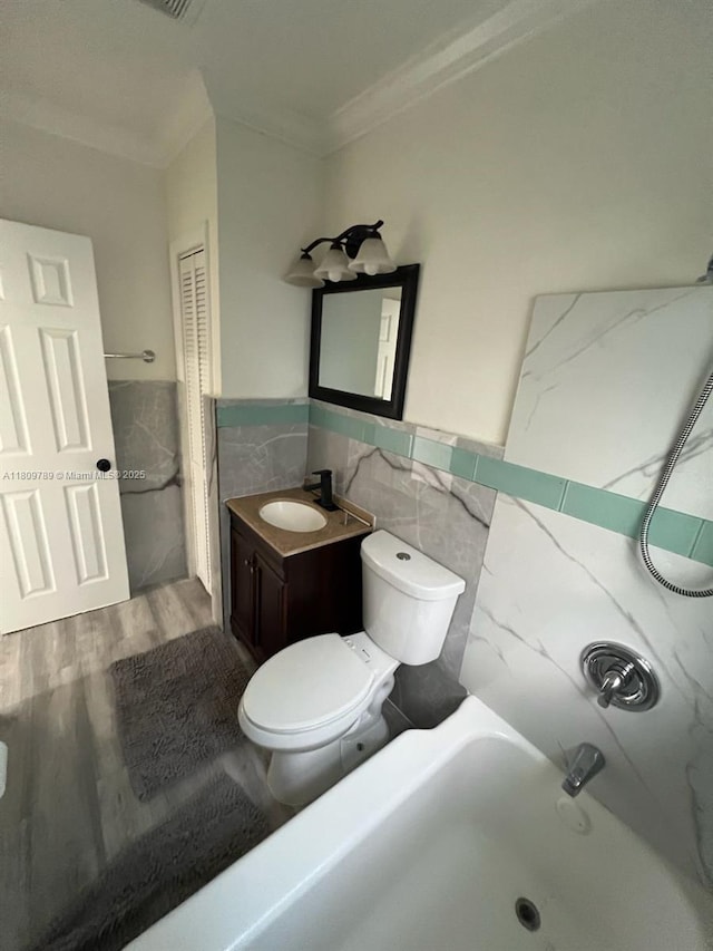 915 N 19th Ave, Hollywood, FL 33020 - full bath with tile walls, ornamental molding, toilet, vanity, and wainscoting