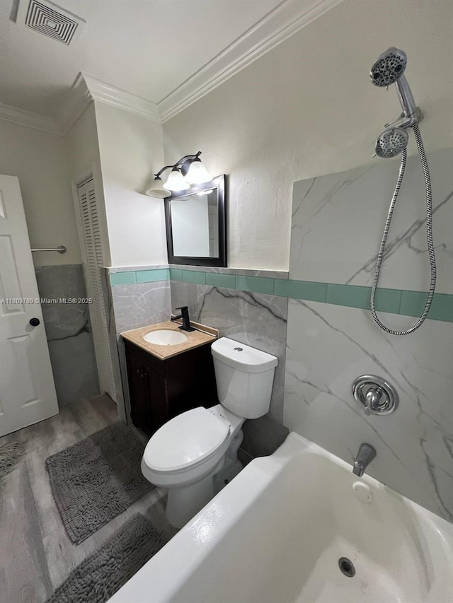 915 N 19th Ave, Hollywood, FL 33020 - full bathroom featuring tile walls, ornamental molding, toilet, vanity, and bathtub / shower combination