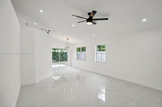 7325 Flores Way, Margate, FL 33063 - unfurnished room with plenty of natural light, recessed lighting, baseboards, a textured ceiling, and lofted ceiling
