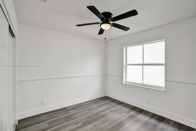 7325 Flores Way, Margate, FL 33063 - empty room with baseboards, wood finished floors, a textured ceiling, and a ceiling fan
