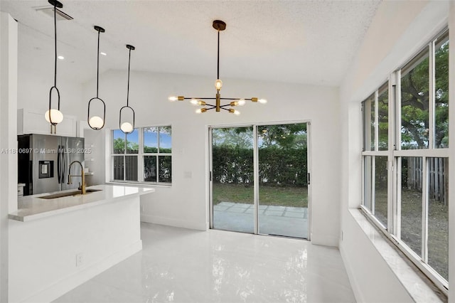 7325 Flores Way, Margate, FL 33063 - kitchen featuring stainless steel fridge, a sink, lofted ceiling, a chandelier, and baseboards