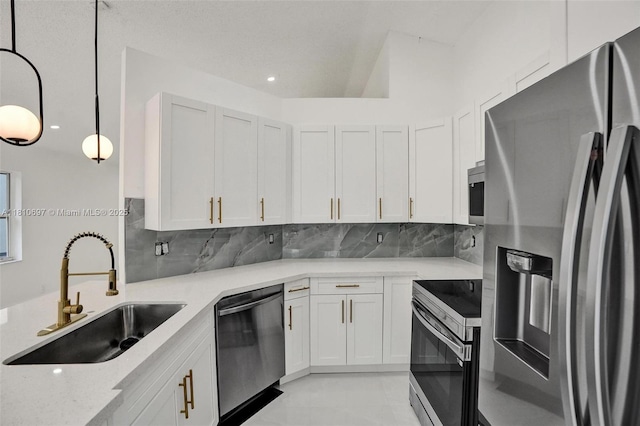 7325 Flores Way, Margate, FL 33063 - kitchen with appliances with stainless steel finishes, a sink, backsplash, white cabinets, and recessed lighting