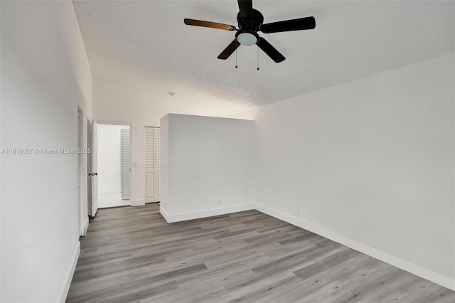 7325 Flores Way, Margate, FL 33063 - spare room featuring wood finished floors, baseboards, a ceiling fan, and a textured ceiling