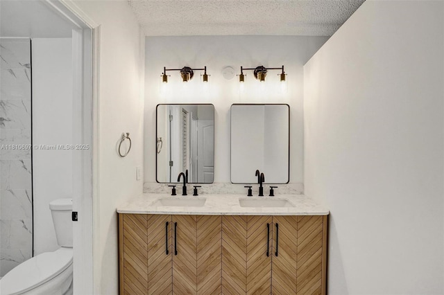 7325 Flores Way, Margate, FL 33063 - bathroom with toilet, double vanity, and a textured ceiling