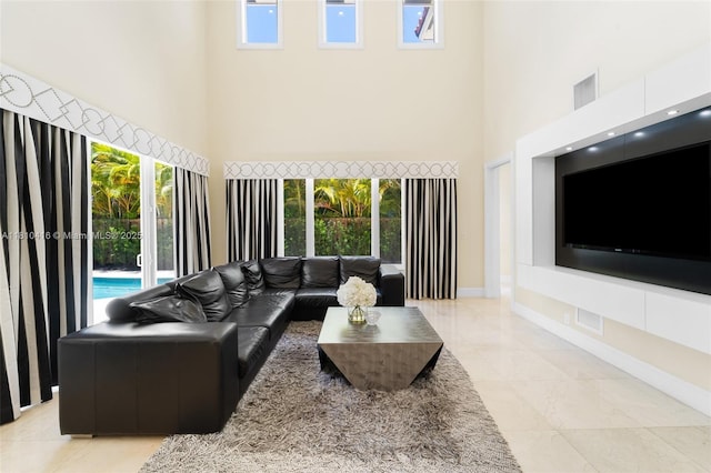 275 189th Ter, Sunny Isles Beach, FL 33160 - living room featuring a high ceiling, baseboards, and light marble finish flooring
