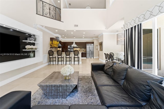 275 189th Ter, Sunny Isles Beach, FL 33160 - living area featuring ornamental molding, a high ceiling, recessed lighting, baseboards, and a chandelier