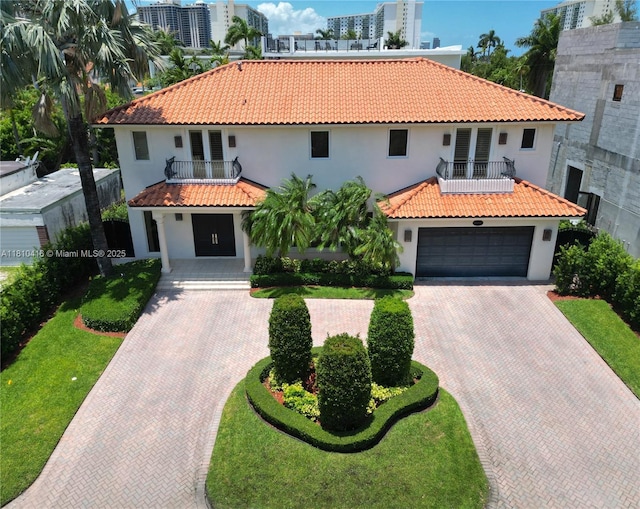 275 189th Ter, Sunny Isles Beach, FL 33160 - mediterranean / spanish home with a balcony, decorative driveway, stucco siding, and a tile roof