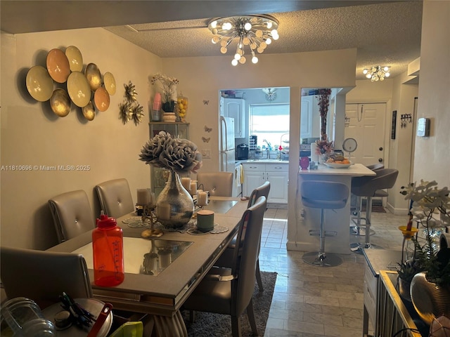 807 W Oakland Park Blvd Unit G1, Oakland Park, FL 33311 - dining room with a chandelier and a textured ceiling