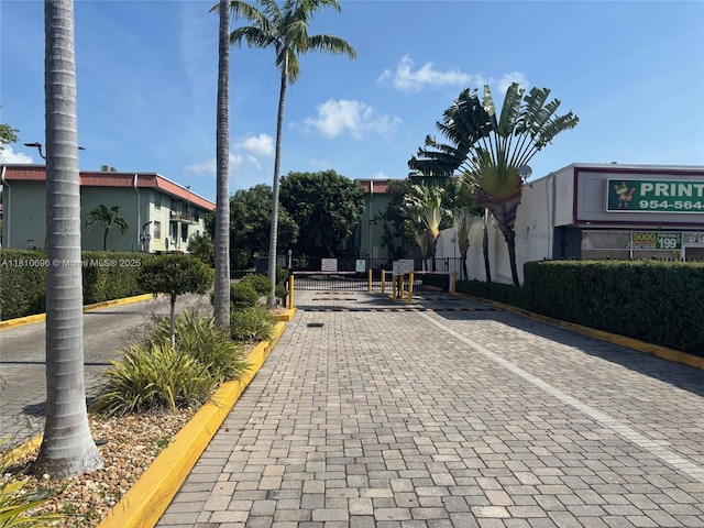 807 W Oakland Park Blvd Unit G1, Oakland Park, FL 33311 - view of road with a gate, curbs, and a gated entry