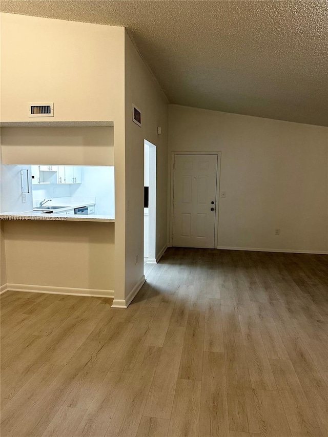 20760 NE 4th Ct Unit 201, Miami, FL 33179 - foyer with wood finished floors, a textured ceiling, and baseboards