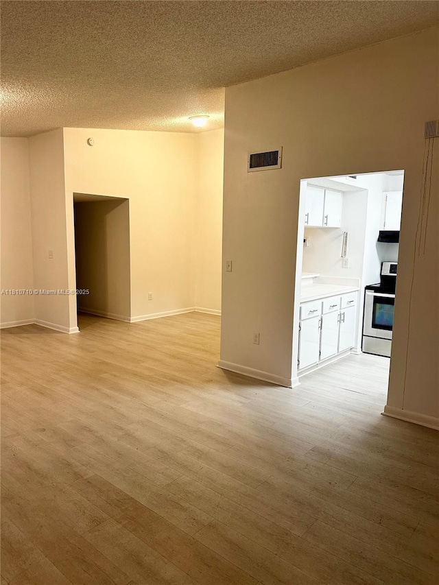 20760 NE 4th Ct Unit 201, Miami, FL 33179 - unfurnished room featuring light wood-style floors, baseboards, and a textured ceiling