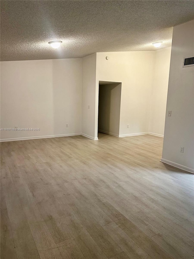 20760 NE 4th Ct Unit 201, Miami, FL 33179 - spare room featuring light wood finished floors, a textured ceiling, and baseboards