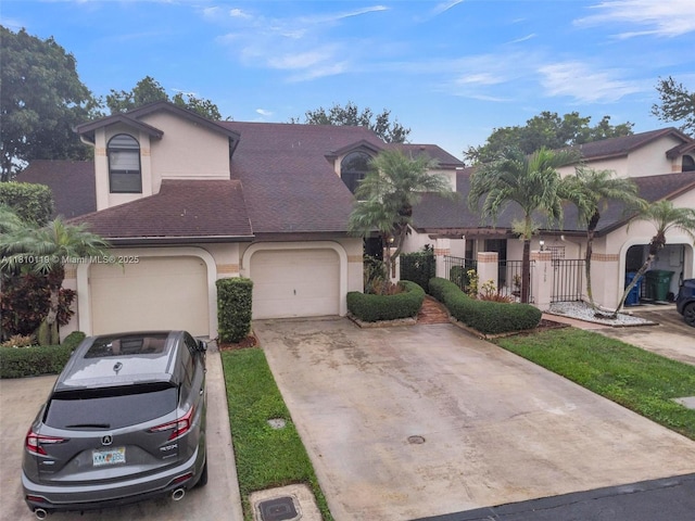 13731 SW 103rd Ter, Miami, FL 33186 - view of front of property with stucco siding, an attached garage, and driveway