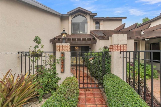 13731 SW 103rd Ter, Miami, FL 33186 - view of exterior entry featuring stucco siding and a gate