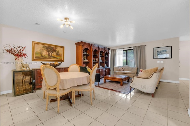 13731 SW 103rd Ter, Miami, FL 33186 - dining room featuring beverage cooler, a textured ceiling, and light tile patterned floors
