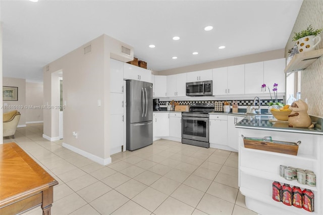 13731 SW 103rd Ter, Miami, FL 33186 - kitchen featuring appliances with stainless steel finishes, white cabinets, recessed lighting, and light tile patterned floors