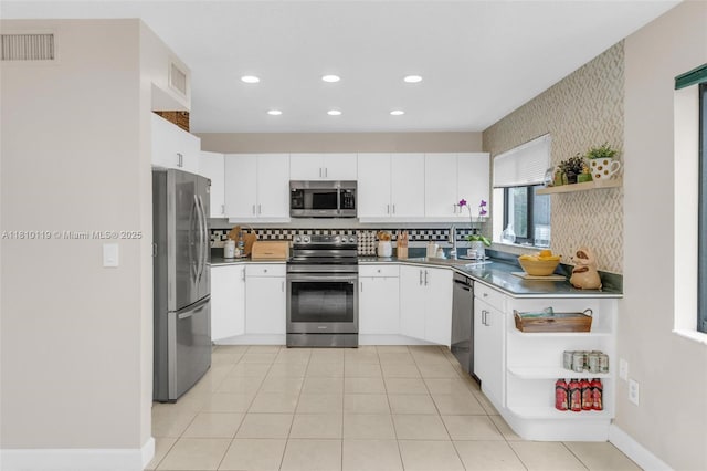 13731 SW 103rd Ter, Miami, FL 33186 - kitchen featuring appliances with stainless steel finishes, open shelves, white cabinetry, recessed lighting, and decorative backsplash