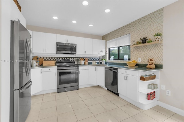 13731 SW 103rd Ter, Miami, FL 33186 - kitchen featuring appliances with stainless steel finishes, open shelves, white cabinetry, recessed lighting, and wallpapered walls