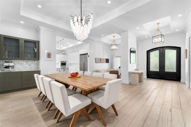 1210 95th St, Bay Harbor Islands, FL 33154 - dining area featuring a chandelier, french doors, light wood-style flooring, recessed lighting, and crown molding