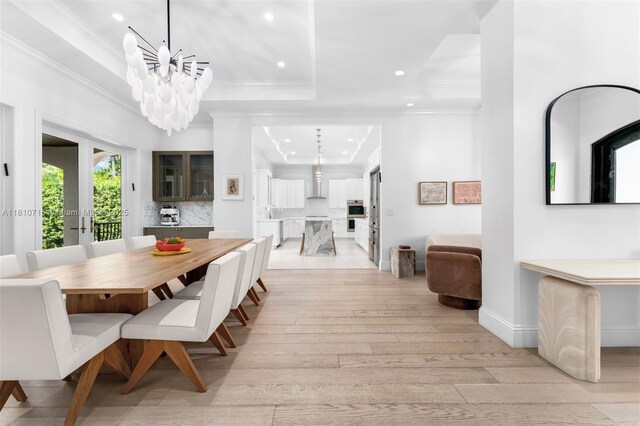 1210 95th St, Bay Harbor Islands, FL 33154 - dining area featuring a tray ceiling, crown molding, recessed lighting, light wood-style flooring, and a chandelier