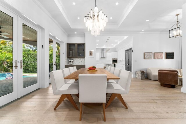1210 95th St, Bay Harbor Islands, FL 33154 - dining area with a chandelier, light wood-type flooring, recessed lighting, crown molding, and a raised ceiling