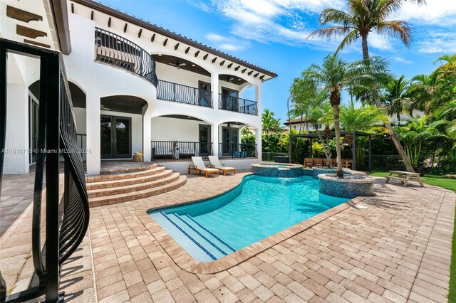 1210 95th St, Bay Harbor Islands, FL 33154 - view of pool featuring french doors, a patio area, and a pool with connected hot tub