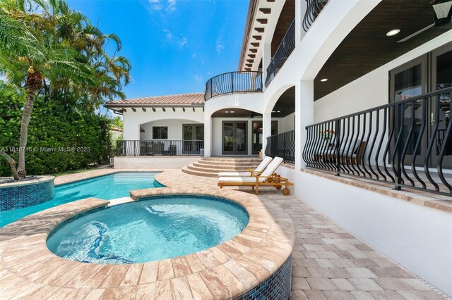 1210 95th St, Bay Harbor Islands, FL 33154 - view of pool with a pool with connected hot tub, a patio area, and french doors