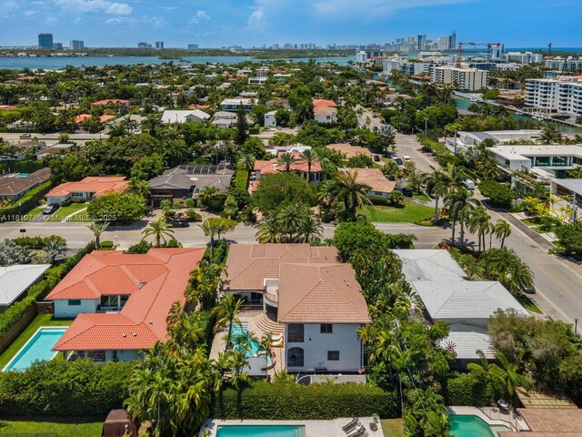 1210 95th St, Bay Harbor Islands, FL 33154 - aerial view of residential area featuring skyline, a pool, and a nearby body of water