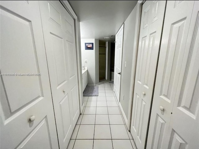 1650 Coral Way Unit 403, Miami, FL 33145 - hallway with light tile patterned floors and baseboards