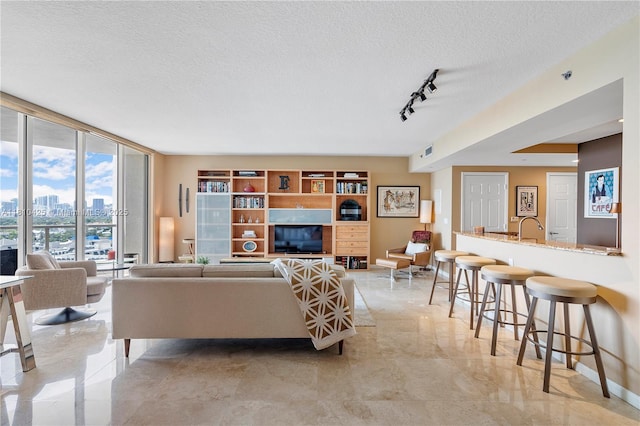 1819 SE 17th St Unit 1501, Fort Lauderdale, FL 33316 - living area with a textured ceiling, expansive windows, track lighting, baseboards, and a city view