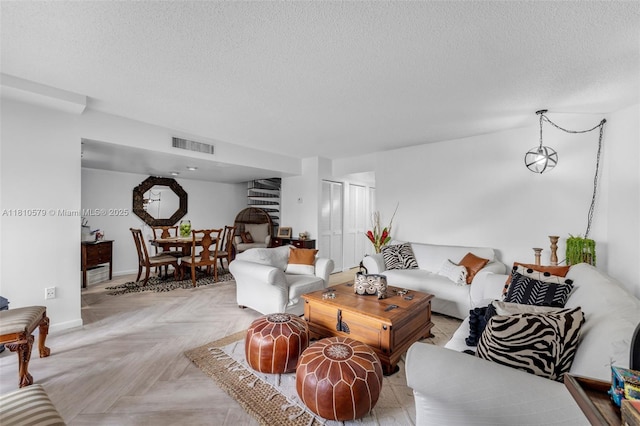 8341 SW 157th Ave Unit 304, Miami, FL 33193 - living room featuring a textured ceiling and baseboards