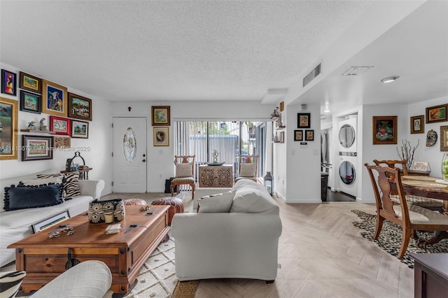 8341 SW 157th Ave Unit 304, Miami, FL 33193 - living area with stacked washer and clothes dryer and a textured ceiling