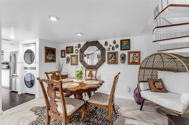 8341 SW 157th Ave Unit 304, Miami, FL 33193 - dining space with stacked washing machine and dryer, baseboards, and recessed lighting