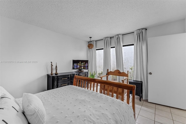 8341 SW 157th Ave Unit 304, Miami, FL 33193 - bedroom featuring a textured ceiling and light tile patterned floors