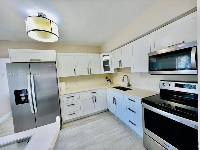1002 S 27th Ave, Hollywood, FL 33020 - kitchen with stainless steel appliances, a sink, and white cabinetry